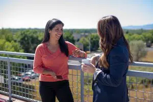 Two women chatting outside.